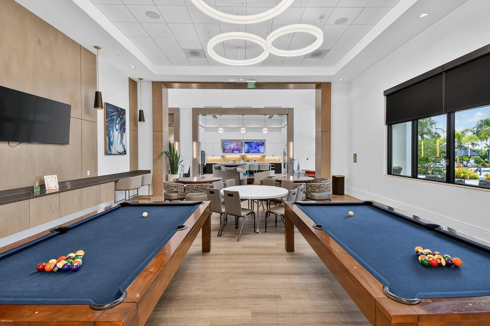 Recreation room featuring two pool tables and wood-finish flooring