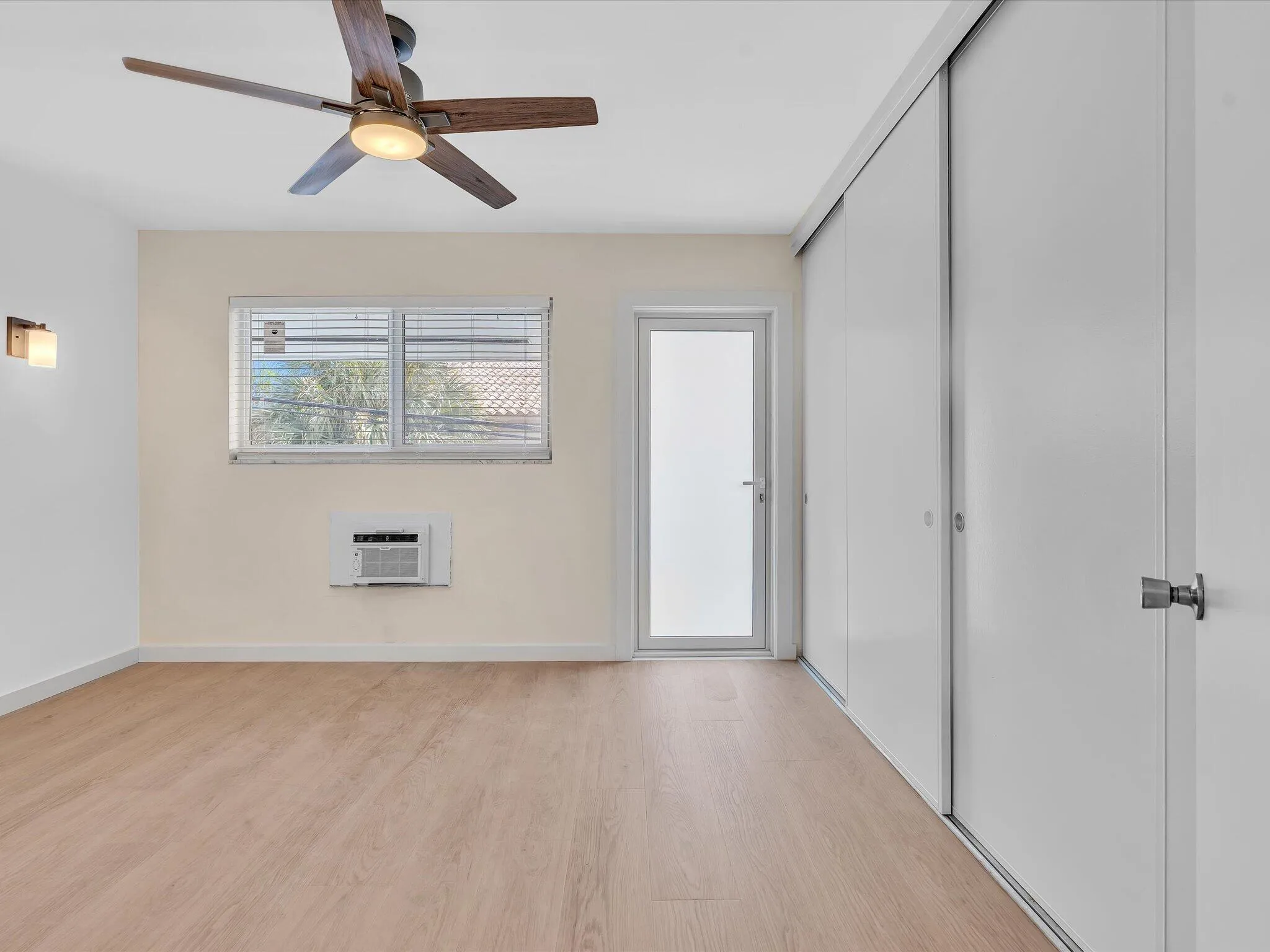 Large bedroom with brand new impact windows, door and A/C unit.