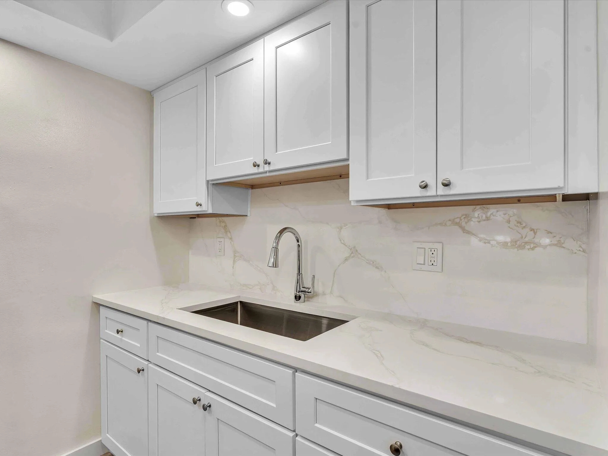 Quartz Counter and backsplash with a deep sink