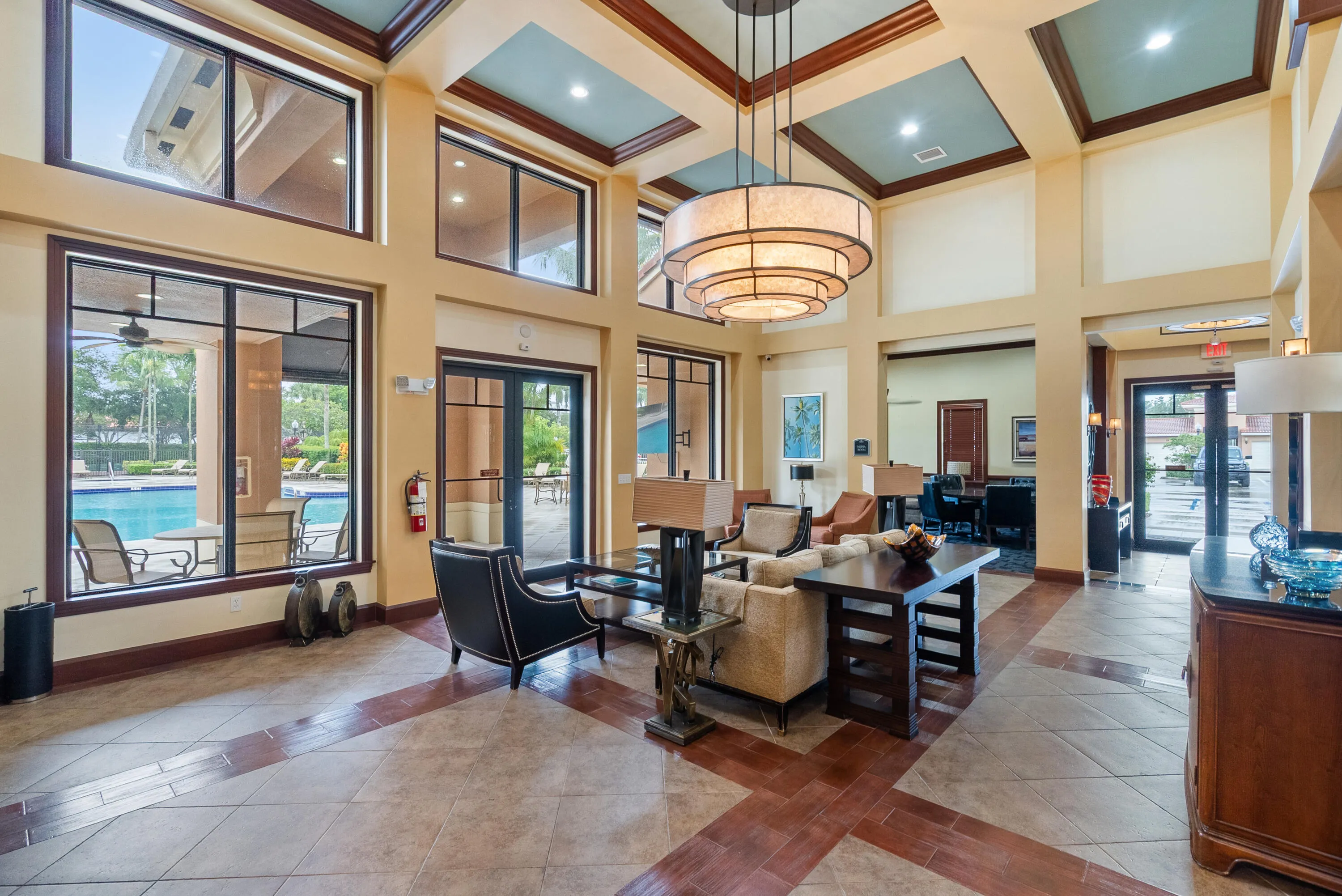 Expansive lobby with high ceilings, recessed lighting, and a multi-tiered chandelier