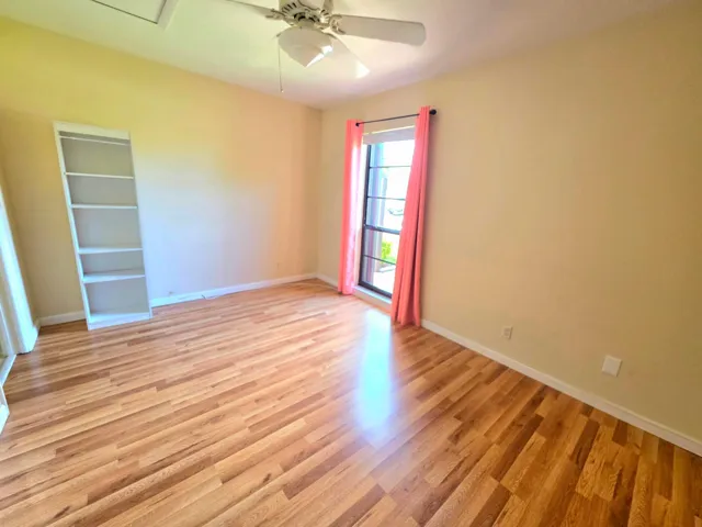 THE SECOND ROOM FACES THE FRONT OF THE PROPERTY WITH LAMINATE FLOORING, EXTRA LARGE WINDOW AND OVERSIZED CLOSET.
