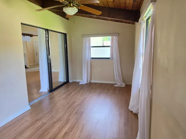EXTRA WINDOWS, EXPOSED WOOD CEILINGS AND PLENTY OF SUNLIGHT IN THIS ENJOYABLE SPACE.