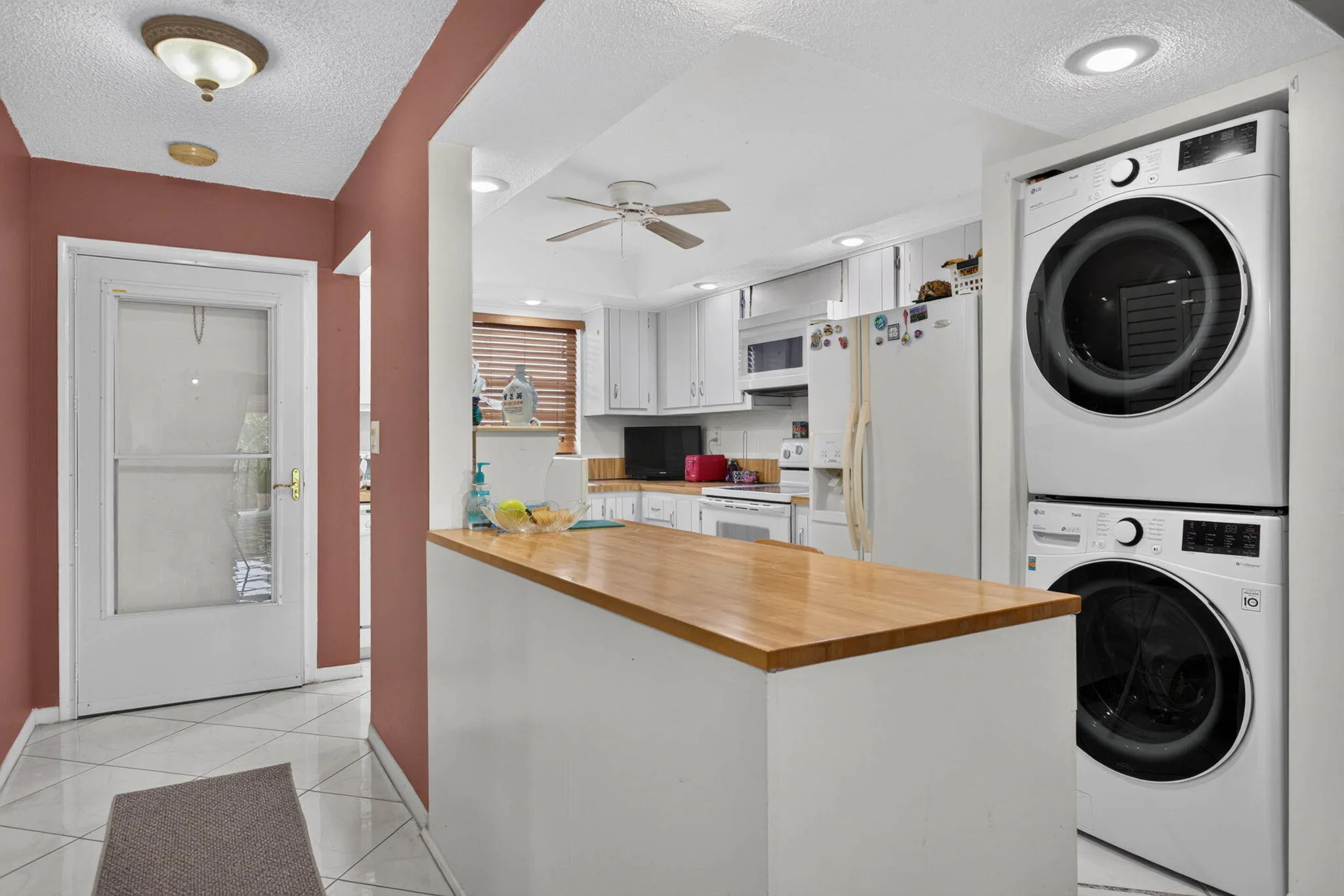 Kitchen featuring white cabinetry, a wood-finish countertop