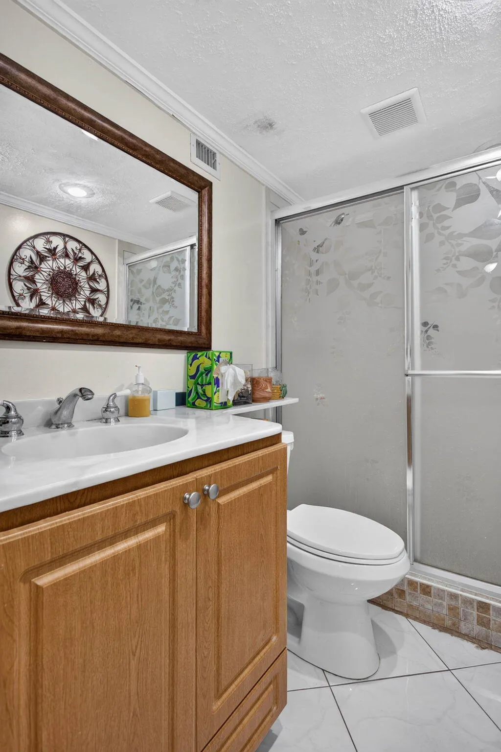 Wood-finish vanity with an integrated sink and chrome faucet
