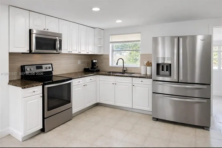Completely updated kitchen featuring sleek stainless steel appliances, modern cabinetry, and ample counter space.