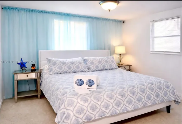 Inviting guest bedroom filled with natural light, modern finishes, and neutral decor.