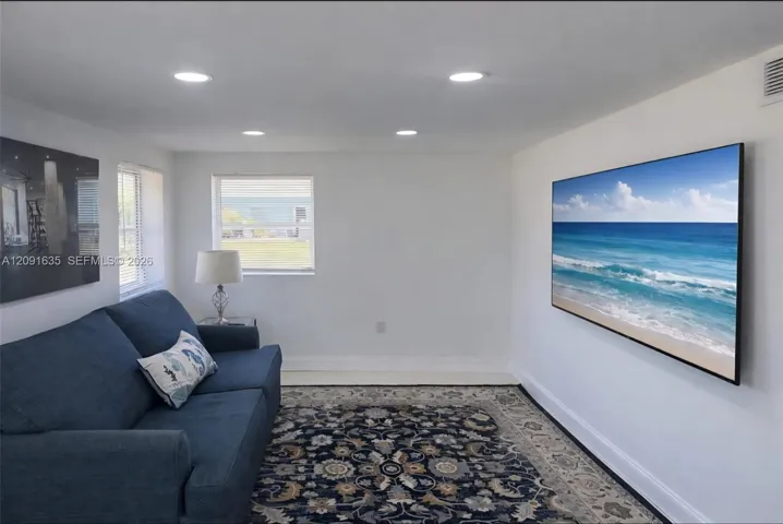 Alternative angle of the expansive living and dining spaces, highlighting the bright, open-concept flow.