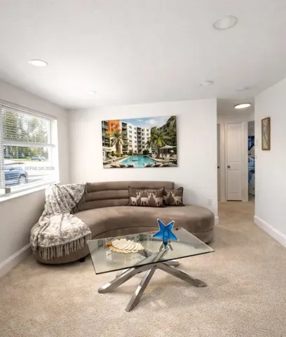 Spacious and bright living area with recessed lighting, designed for comfortable everyday living and entertaining.