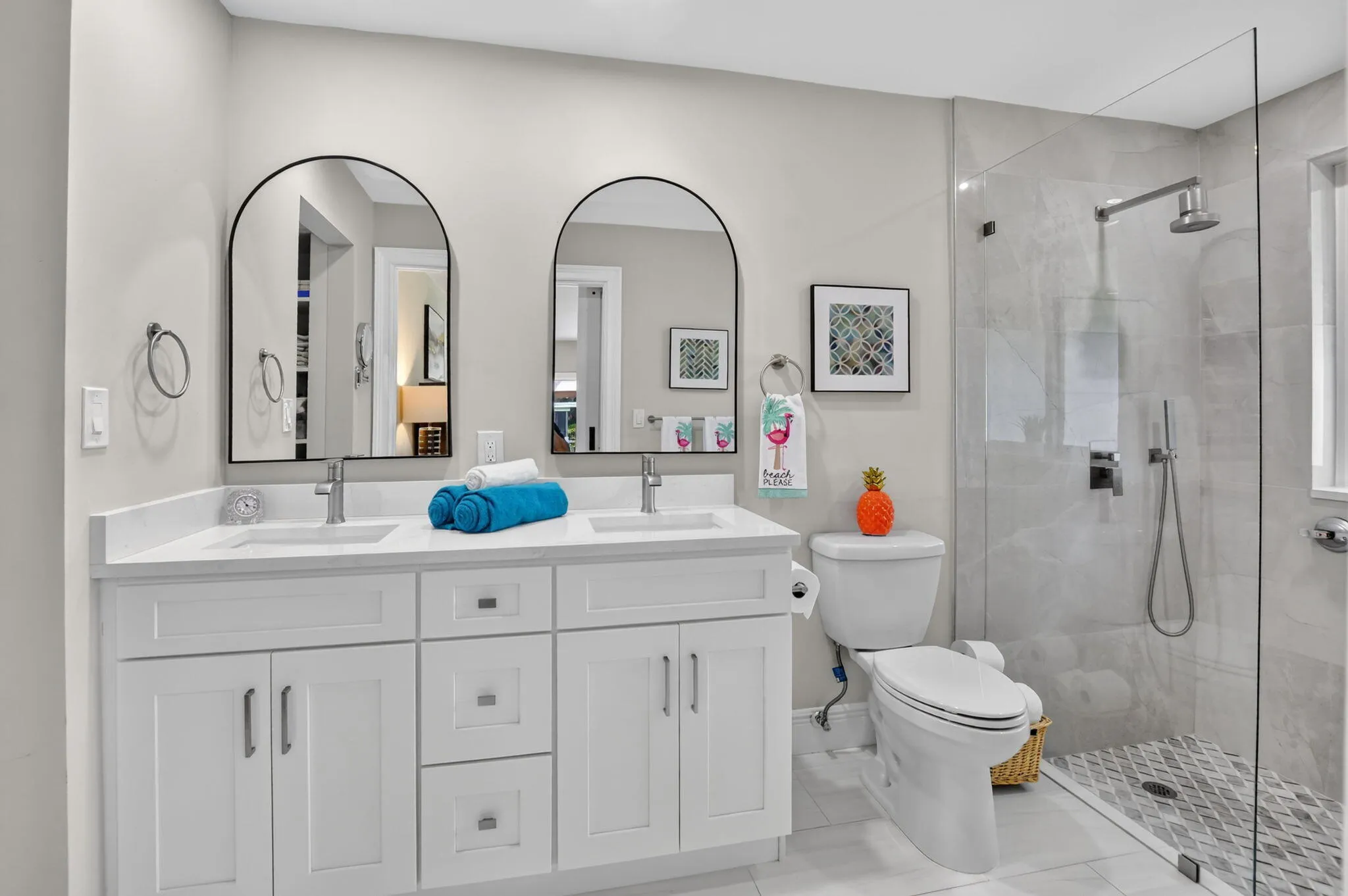 Primary bath features a counter height vanity with sparkling quartz countertop and double basin, undermount sinks.