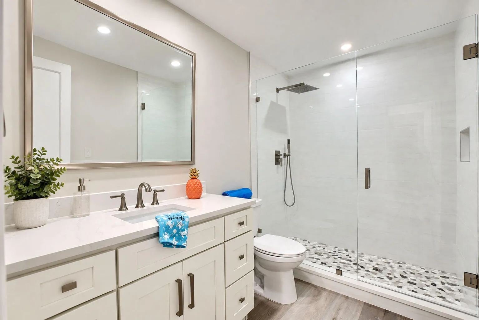 Guests will love the updated bath with quartz vanity and framless shower. Amazing pebble flooring.
