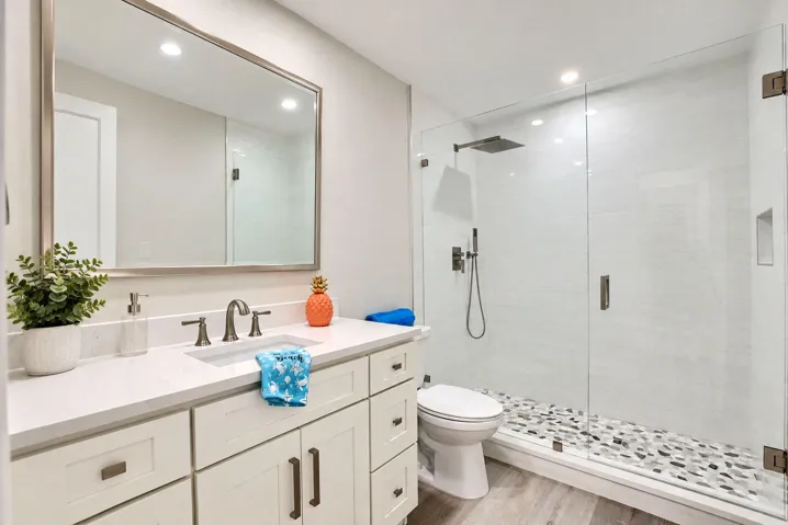 Guests will love the updated bath with quartz vanity and framless shower. Amazing pebble flooring.
