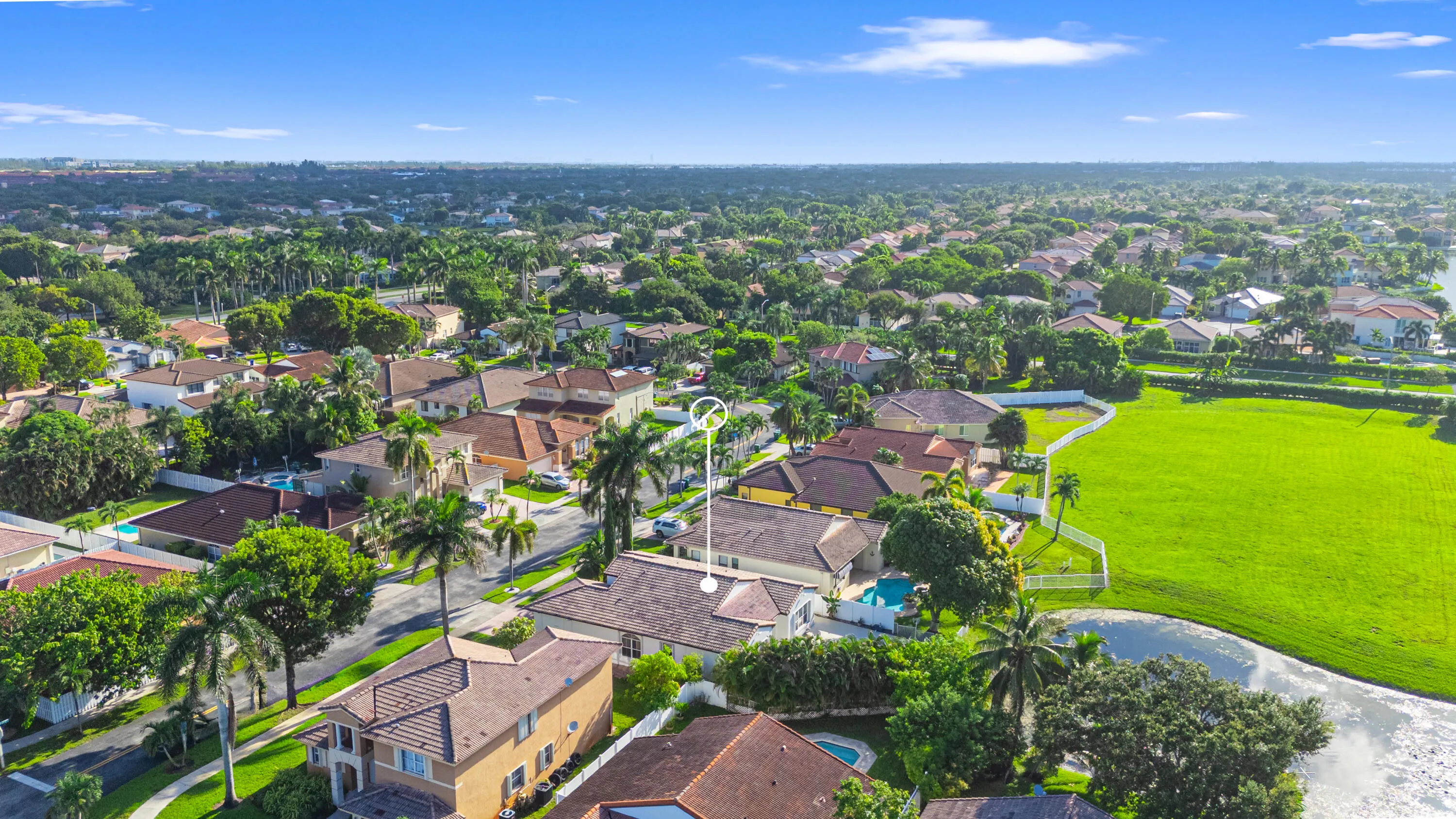 Aerial view provides additional perspective on the home’s setting among neighboring residences and preserve.