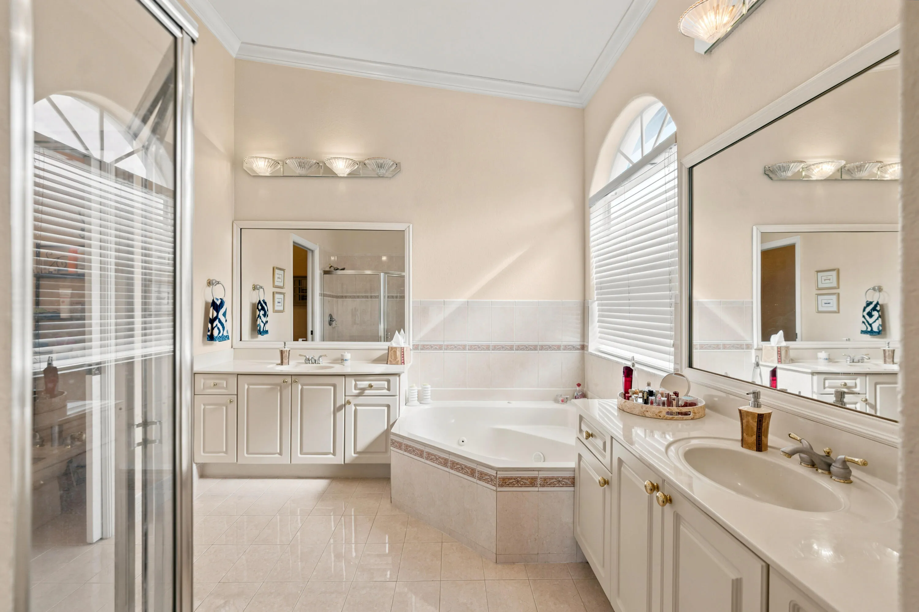 A jetted soaking tub, separate shower and dual vanities create a well-appointed primary bath.