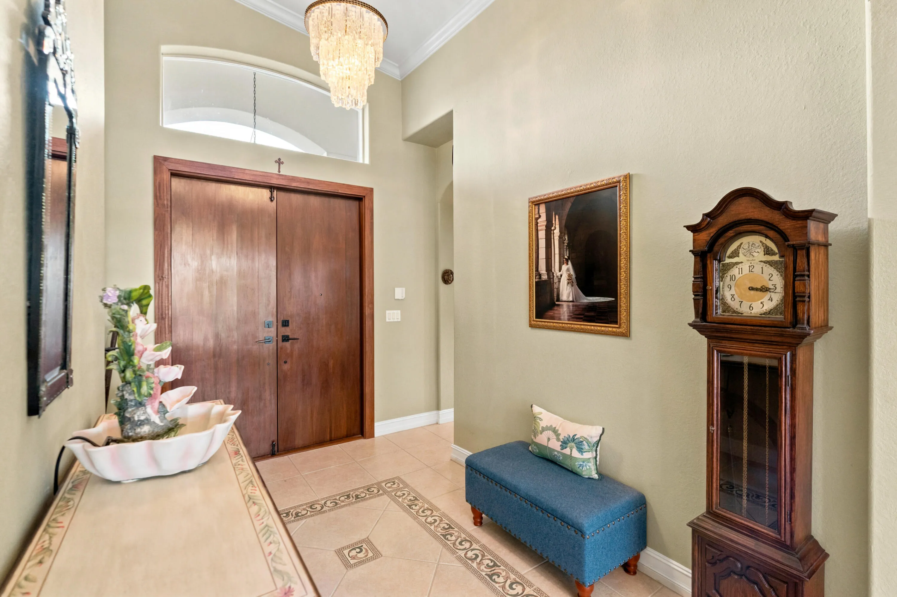 Double entry doors and a high transom window create a bright, welcoming arrival.