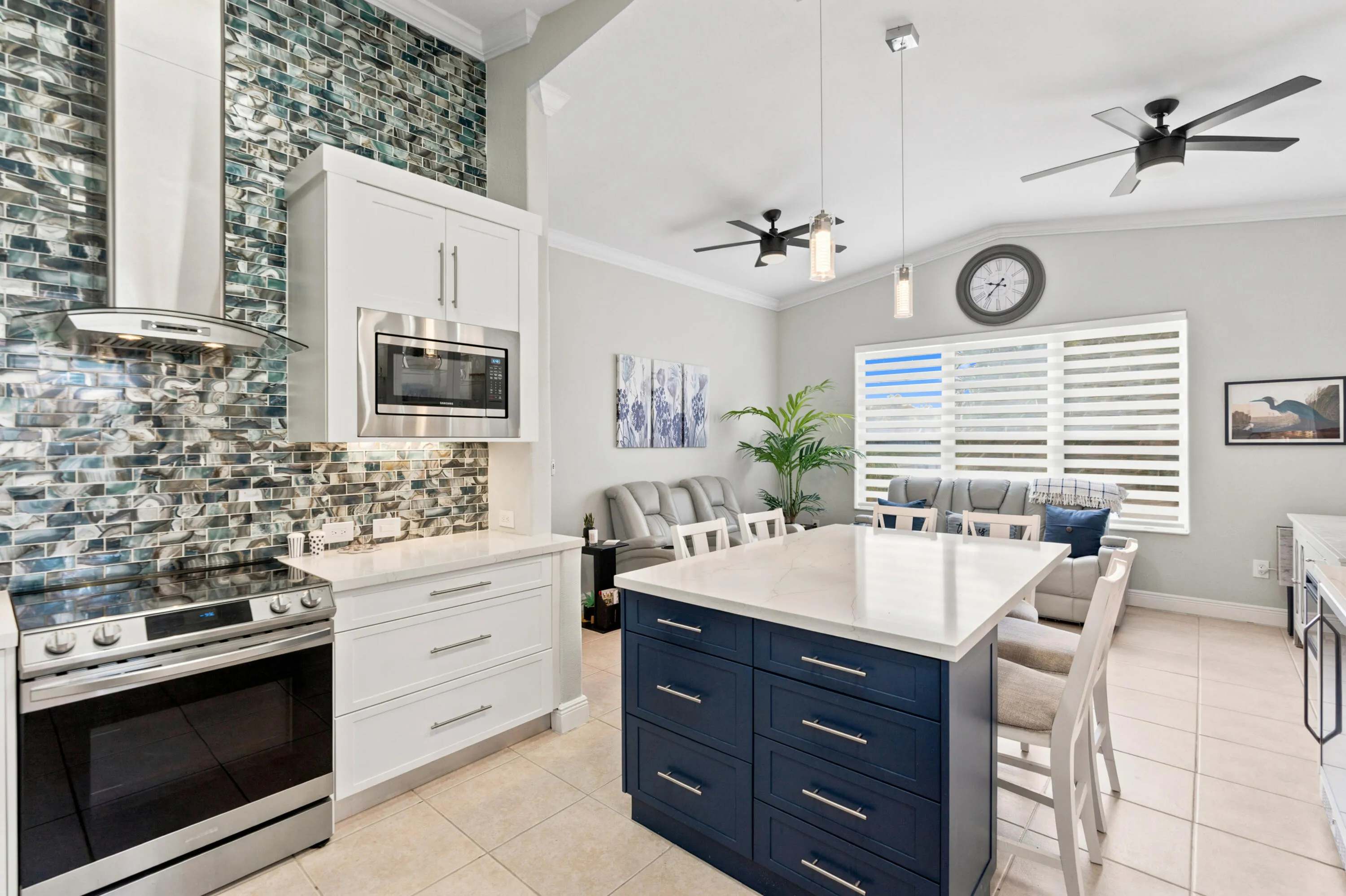 The contrasting center island adds generous workspace and seating within the open kitchen.