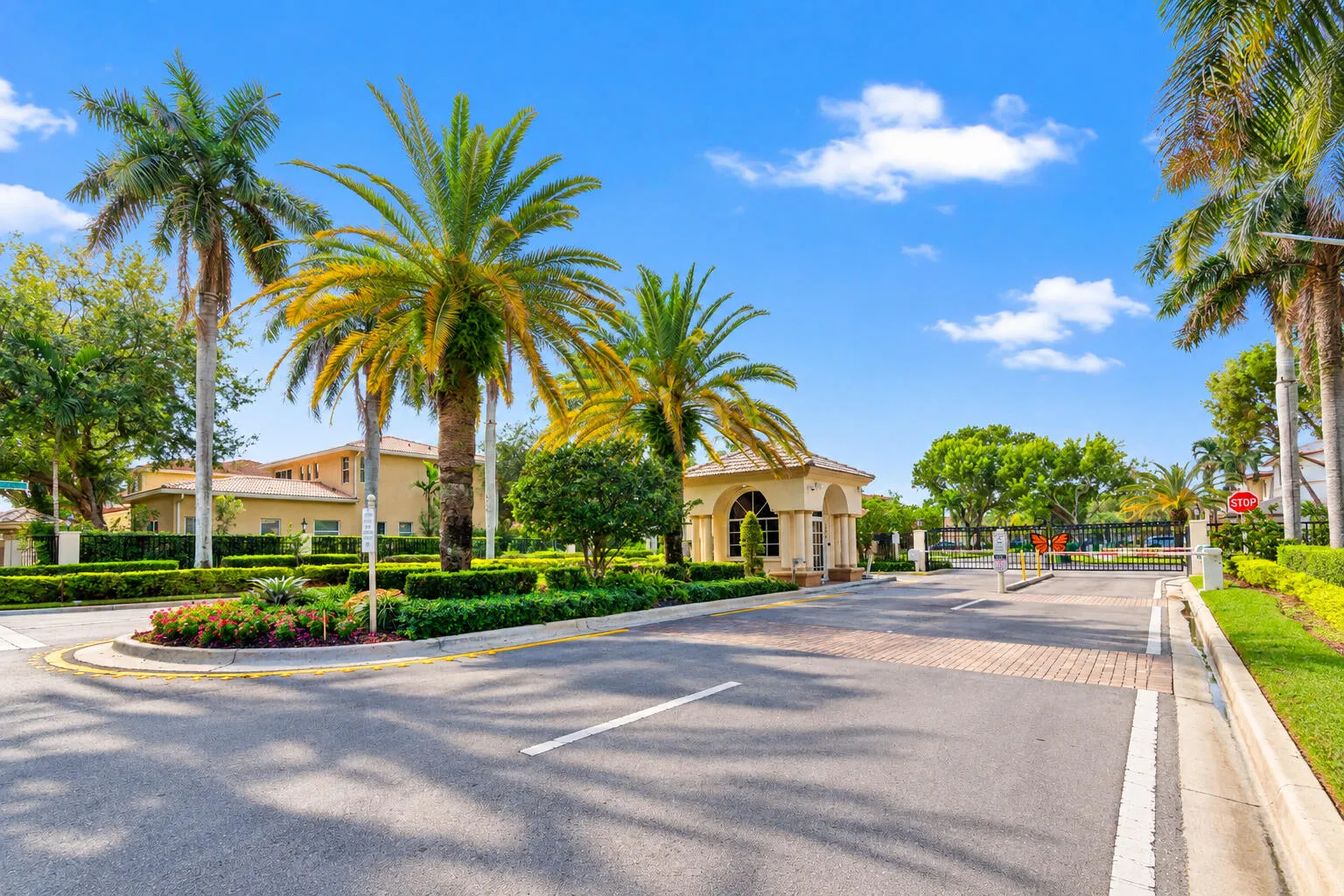 Landscaped gated entrance welcomes residents and guests into The Estates at Tequesta Cove.