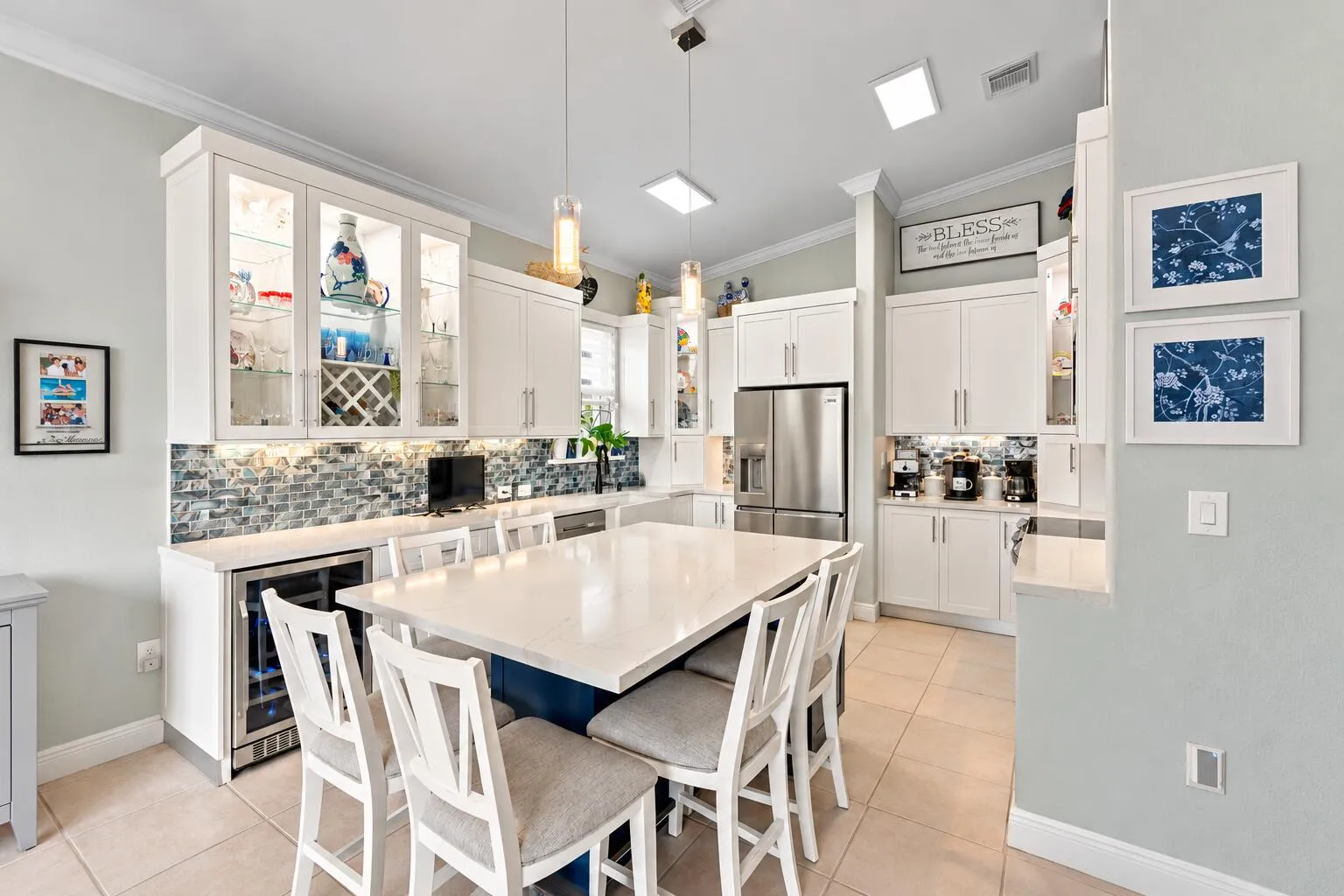 A generous center island provides abundant surface space for casual dining and gathering.