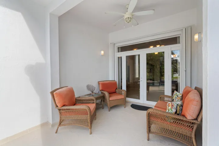 This outside patio creates a comfortable transition from indoor living to the pool and backyard.