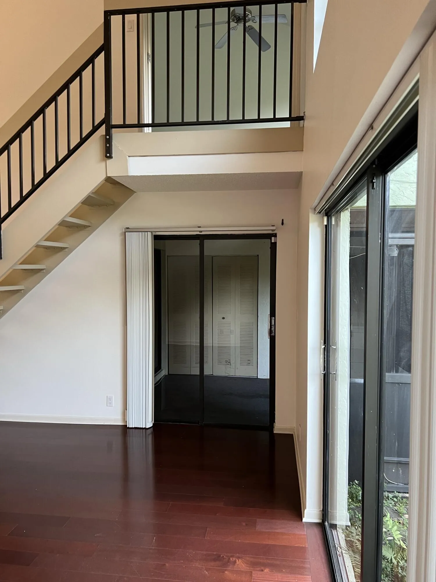 Stairs to the primary bedroom behind double privacy doors.