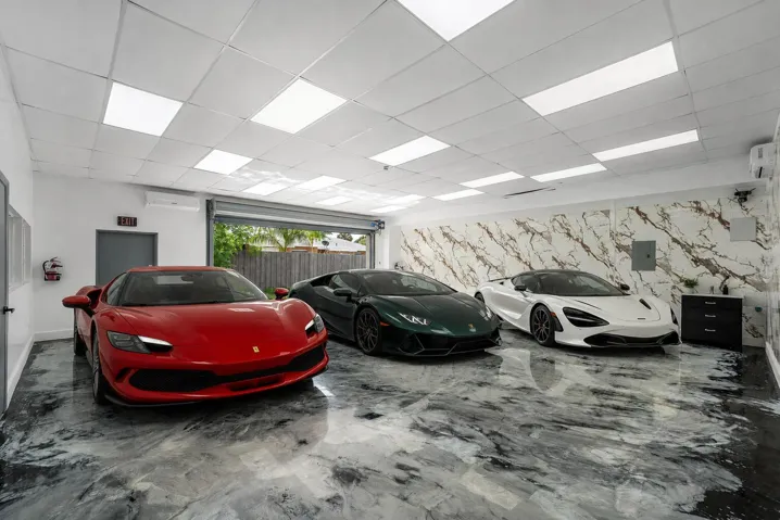 Currently configured as a private auto gallery, this expansive space features a wide roll-up entrance, bright overhead lighting, and distinctive polished flooring. Its flexible layout offers possibilities for vehicle display, creative workspace, storage, or other permitted uses.
