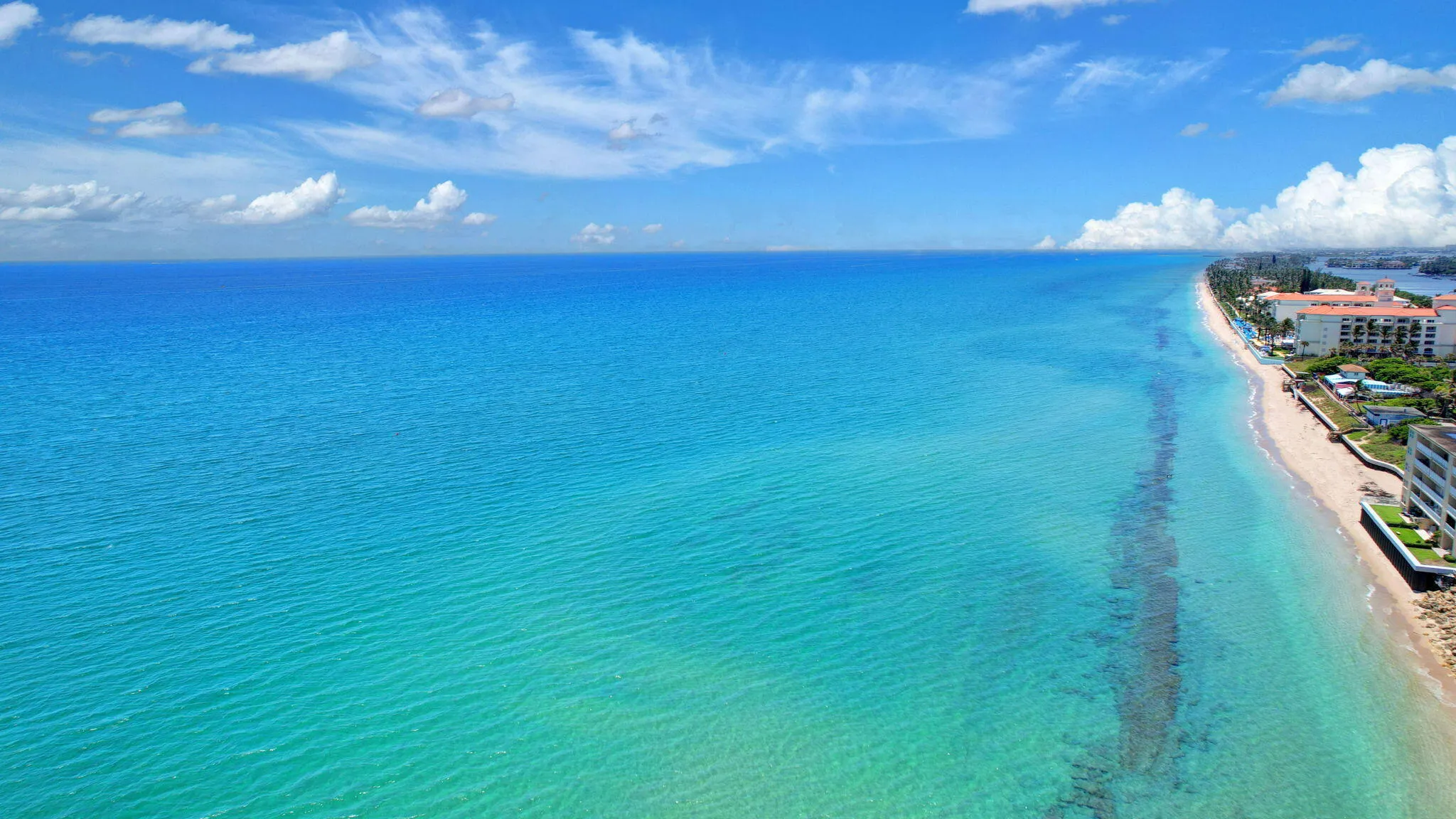 Expansive coastline featuring turquoise waters and a sandy beach