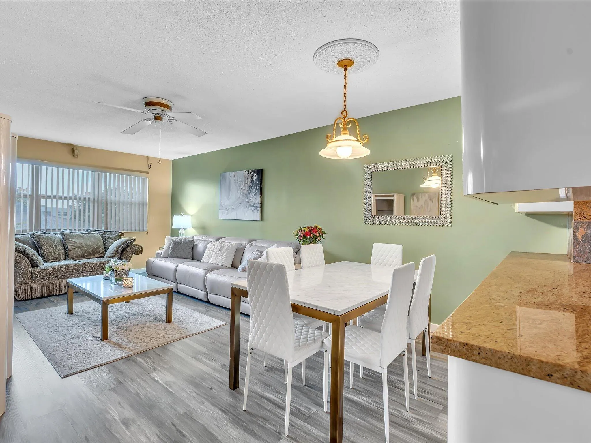 Wood-finish flooring throughout, ceiling fan, window blinds, and built-in ceiling light fixture