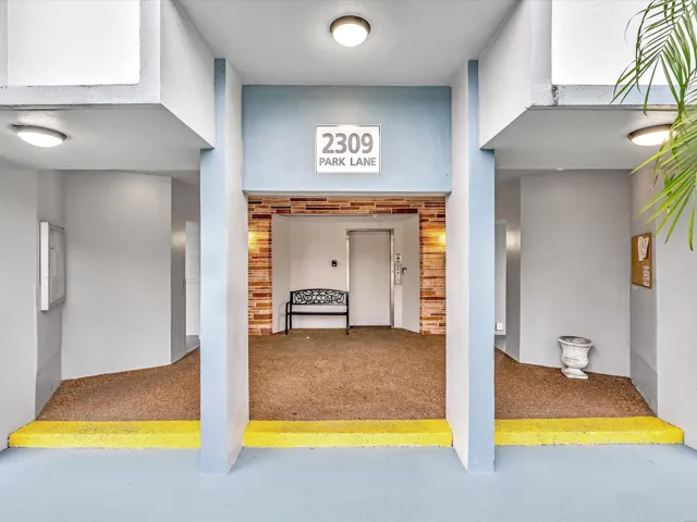 2309 Park Lane features three distinct room entries with bright yellow threshold accents and cork flooring