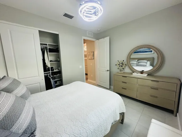 front guest bedroom with custom closet & lighting