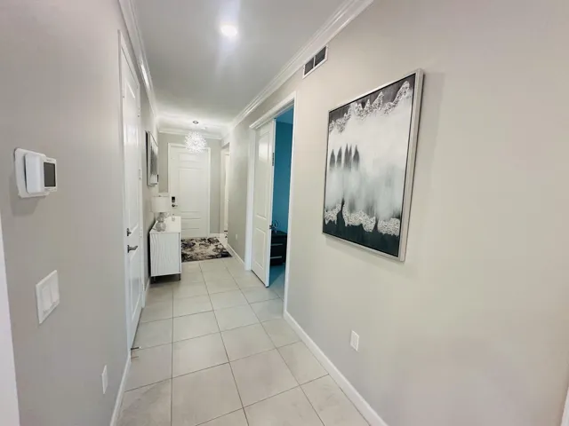 front door entrance- 2 guest bedrooms -guest bathroom and laundry room on the right and door that opens to the one car garage on the left before entering into the kitchen/living area