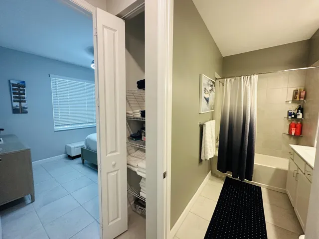 Front guest bedroom-linen closet and guest bathroom with tub & shower
