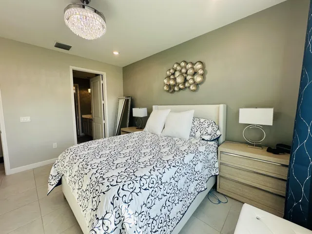 Master bedroom with entrance to master bathroom & walk in custom closet