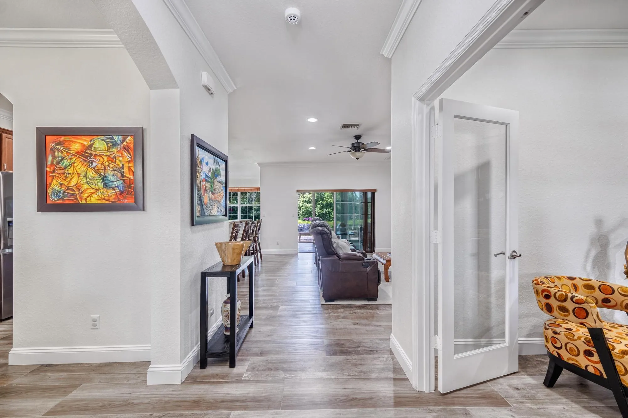 Foyer Opening to the Family Room with Sliders to the Sunroom and Lake