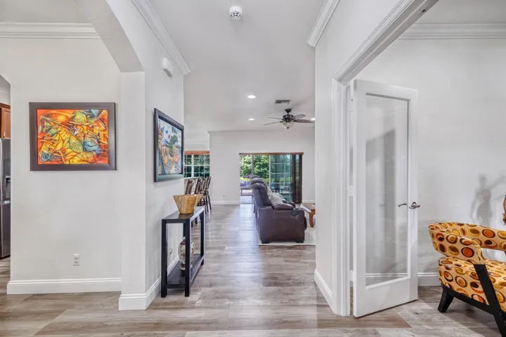 Foyer Opening to the Family Room with Sliders to the Sunroom and Lake