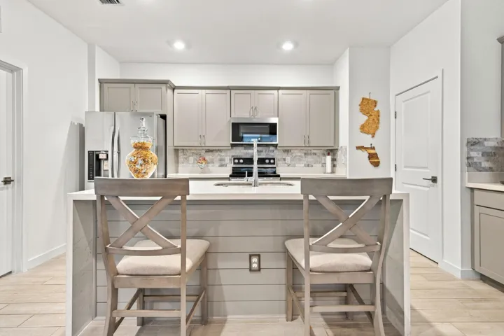 Customed Kitchen with waterfall quartz countertop, recessed lights, 42' cabinets with crown molding,