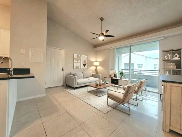VAULTED CEILINGS AND PORCELAIN TILES THROUGHOUT. virtually staged.