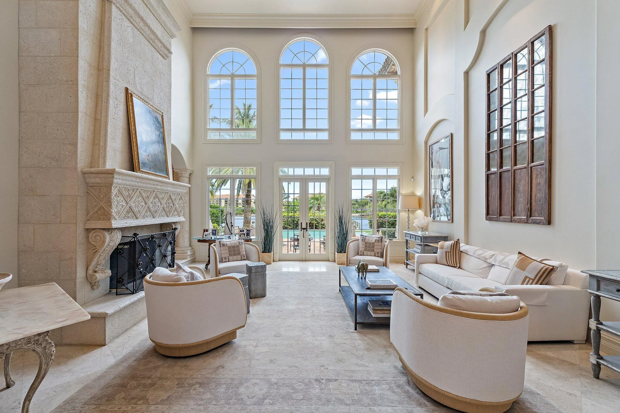 floor to ceiling windows, marble floors + a grand fireplace