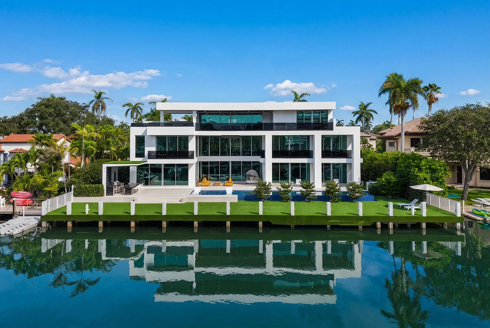 Magnificent waterfront estate commanding 125 feet of deep-water frontage on an exceptionally wide canal, featuring a spectacular 75-foot infinity-edge pool, expansive turf-finished dock, and three extraordinary levels of modern luxury.