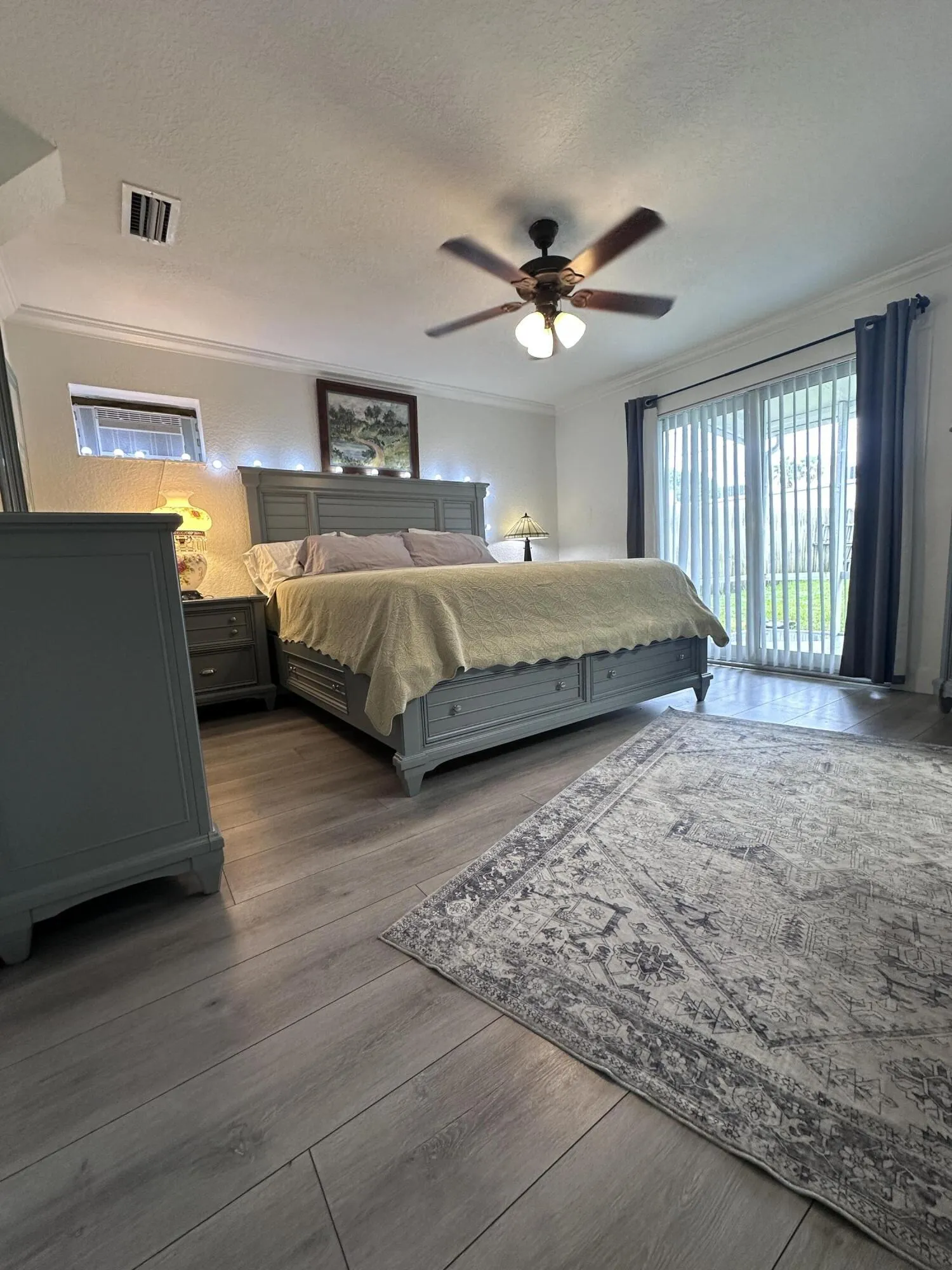 New flooring extends from living area, hurricane impact sliders walk out to covered porch and backyard.
