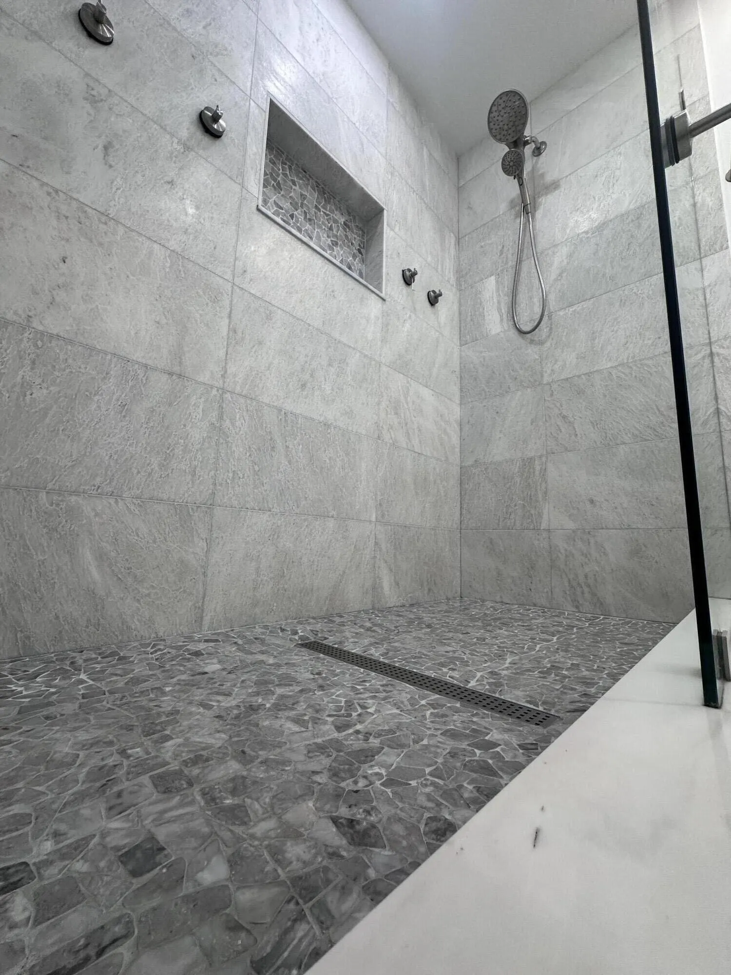 Walk in Shower finishing details of stone and marble.