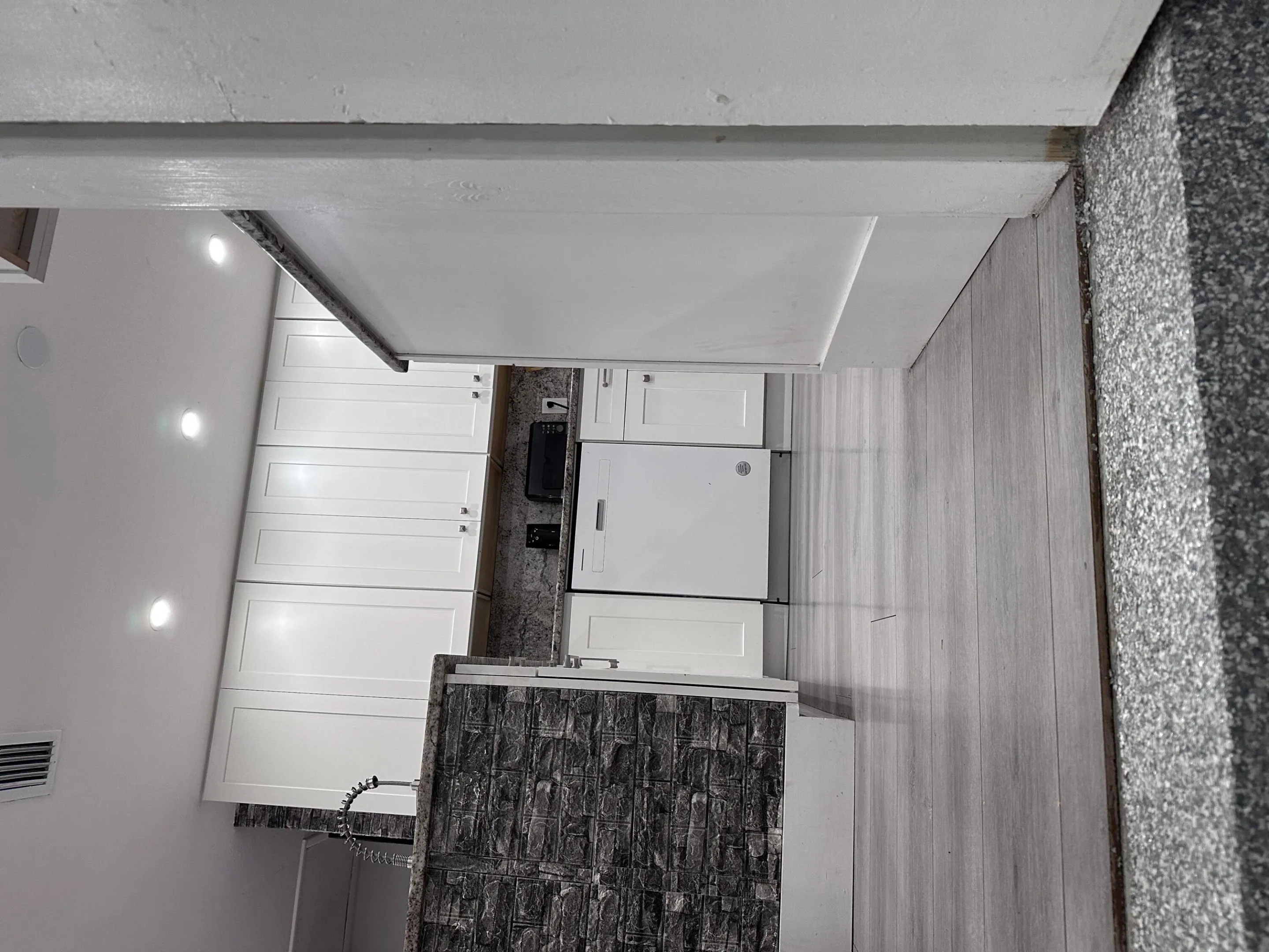 Same granite counter flows from kitchen into laundry area. New electric appliances.