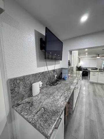 Office Desk Cutout at workspace, TV Wall Mounted for more space.