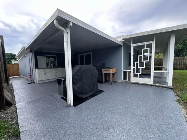 Cover outdoor BBQ kitchen, resurfaced concrete patio. Covered patio to right is not screened in.