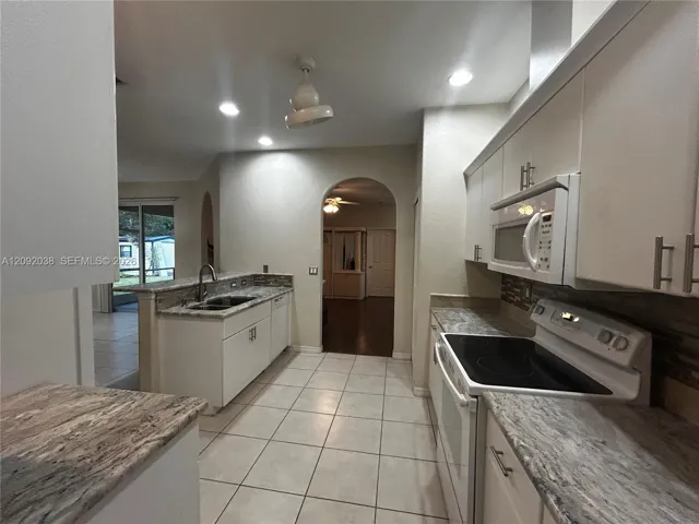 Refrigerator, electric stove, microwave, dishwasher, and pantry.
