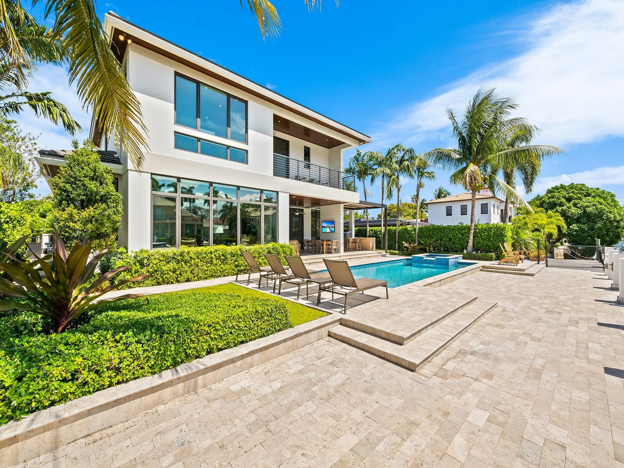 A backyard oasis complete with a sparkling pool/spa and a stylish summer kitchen