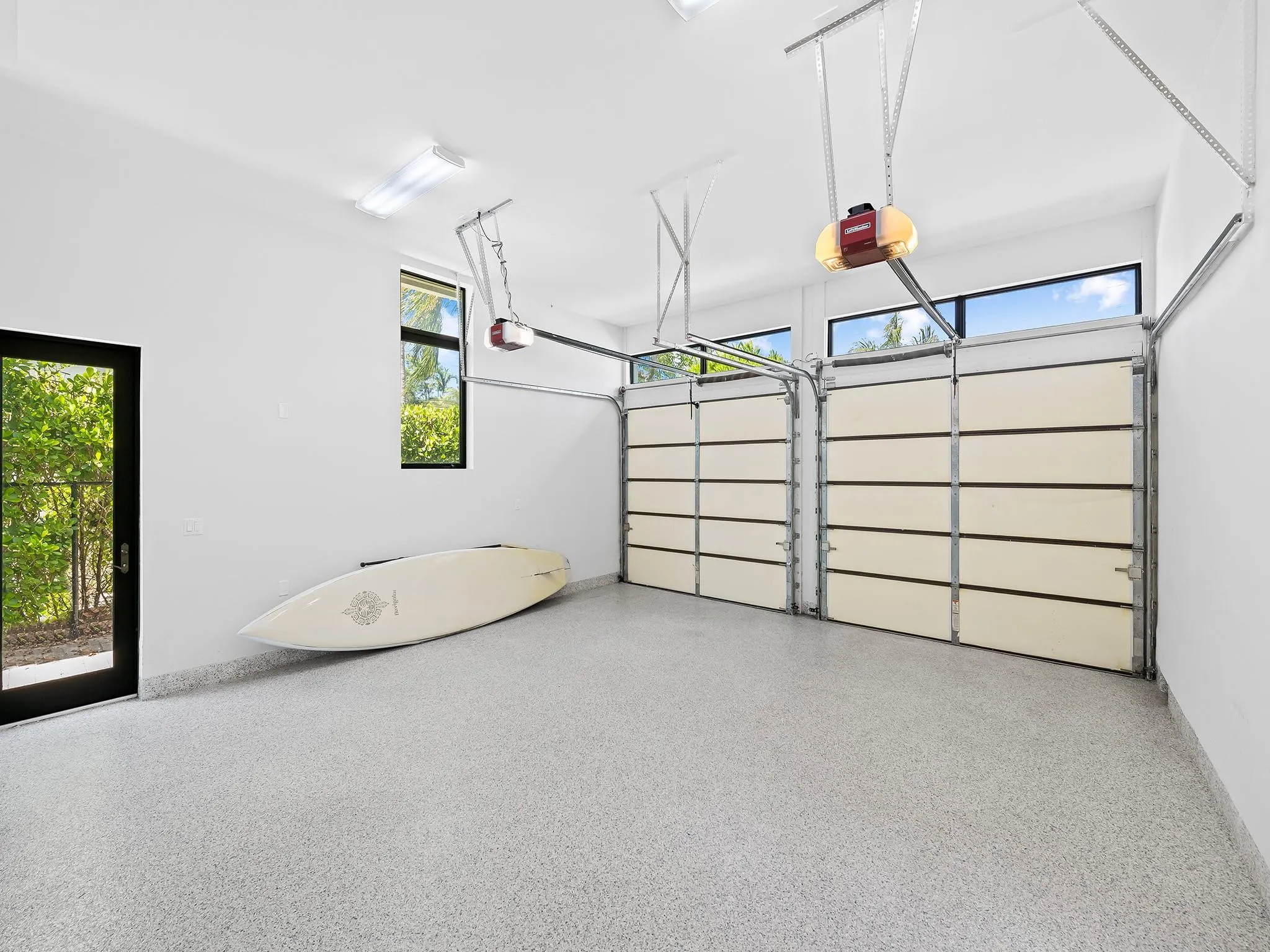 Two car garage with oversized storage closet.
