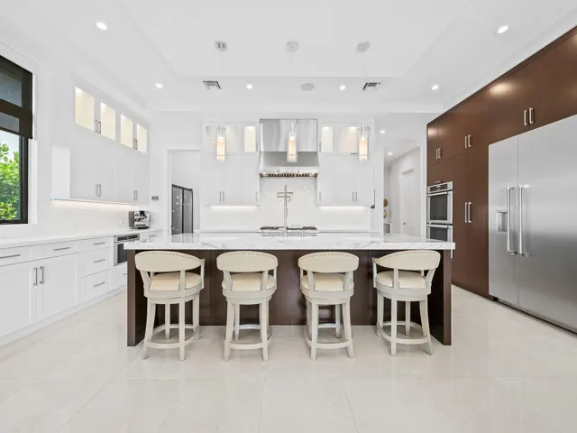 A pristine view into the kitchen reveals its beauty, showcasing elegant finishes and high end appliances