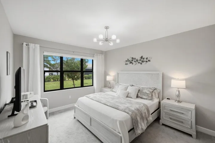 Open-concept room featuring light-toned walls and wood-finish flooring
