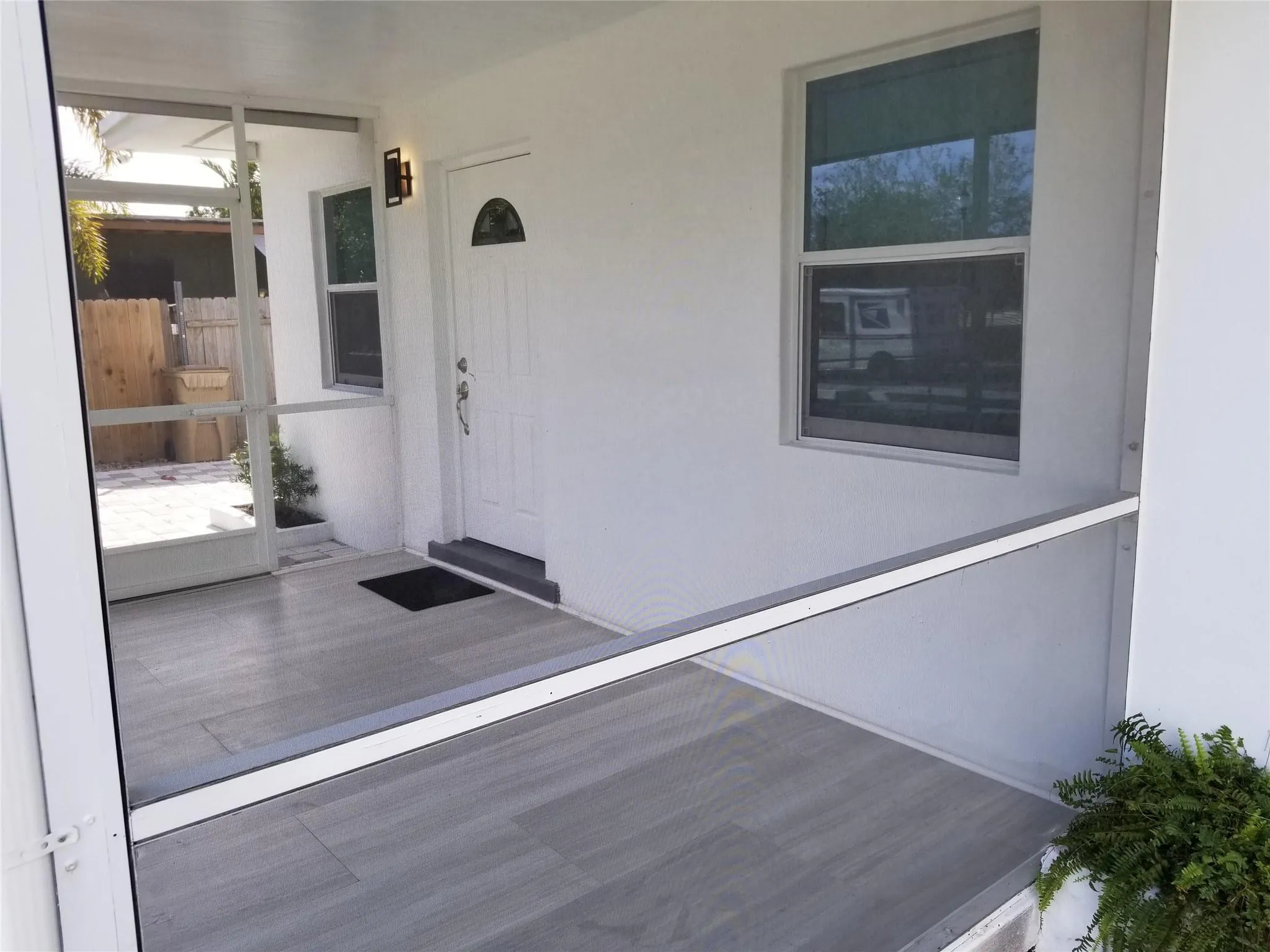 Screened-in porch featuring wood-finish flooring