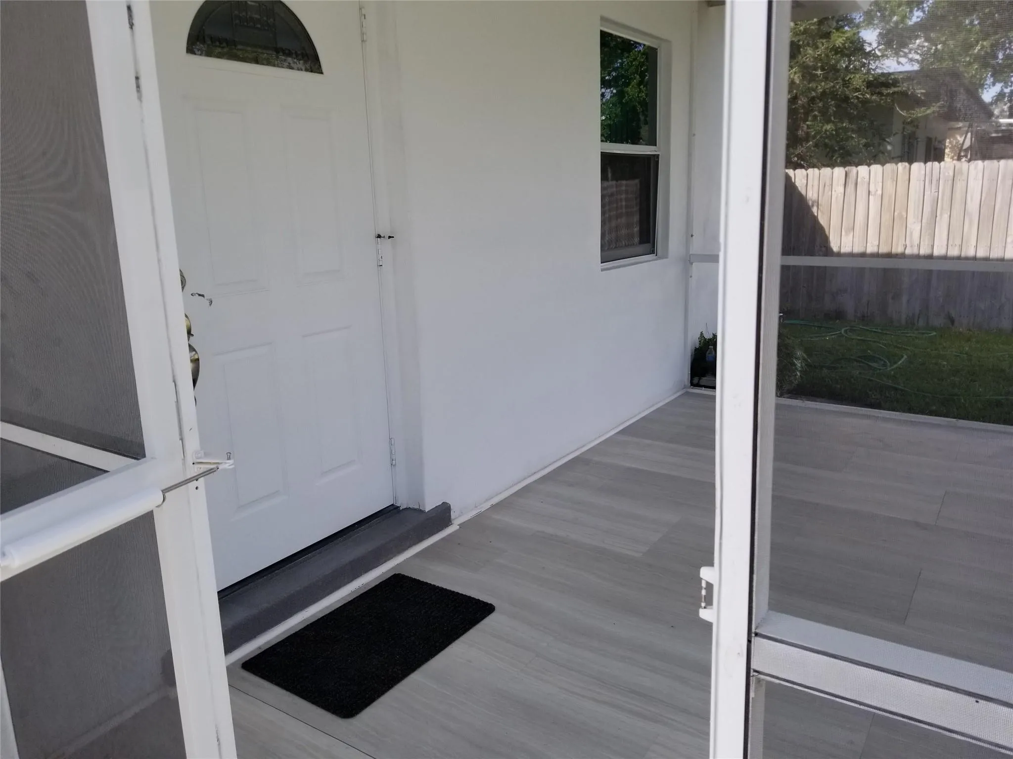 Screened porch with wood-look tile flooring