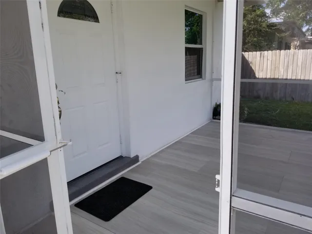 Screened porch with wood-look tile flooring